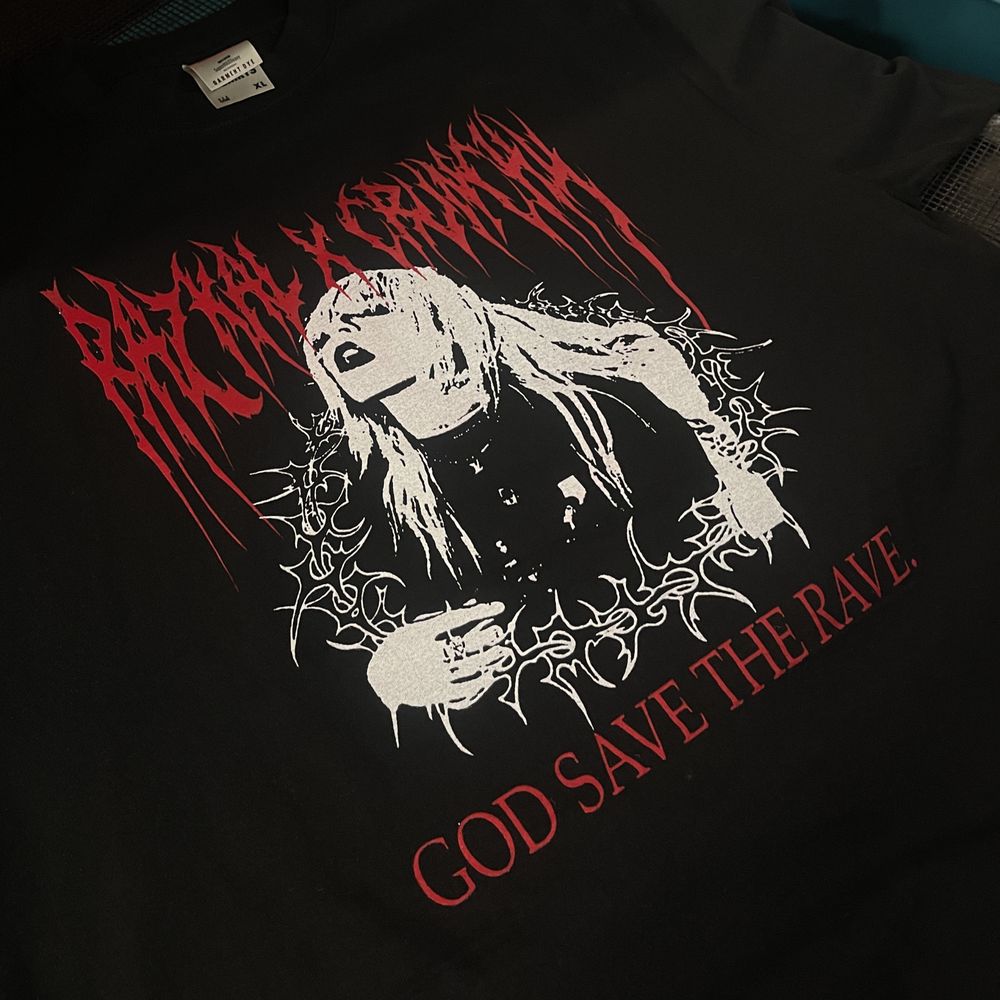 Two-color red and white halftone print reading God Save the Rave on a black shirt
